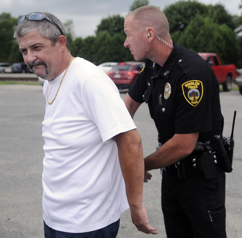 Winslow Police Officer John Veilleux arrests Fred Horne Sr. Sunday, July 27, 2014, in the parking lot of Fort Halifax Park in Winslow. Horne was charged with two counts of violating conditions of release when he gave away bride Theresa Rice-Goodrich during her nuptials held in the gazebo at the Park.
