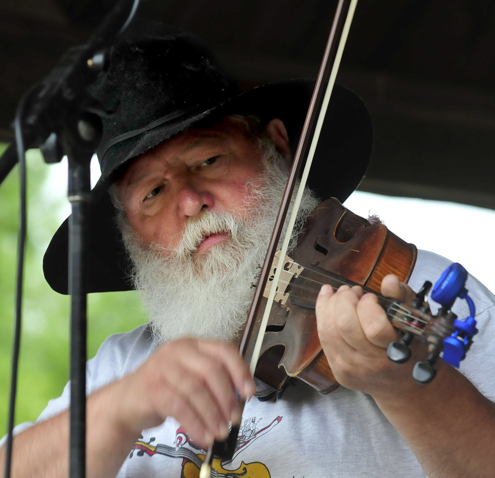 Fiddler Danny Thompson competes in the 42nd East Benton Fiddlers Convention on Sunday, July 27, 2014. After his performance the music was stopped as equipment was moved under cover before a hard rain fell.