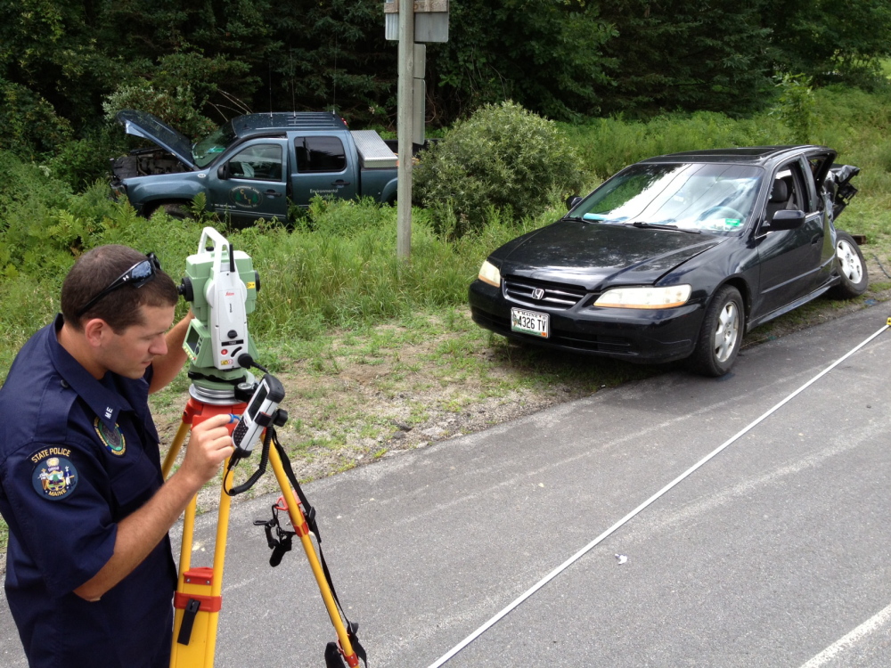 State Trooper Michael Pion reconstructs a two-car collision that claimed the life of man a couple minutes this morning in Vassalboro.