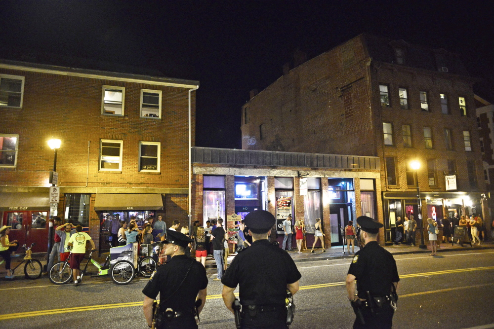 Police officers patrol Fore Street in the Old Port after 1 a.m. Sunday, July 6, after the Independence Day weekend celebration in downtown Portland.