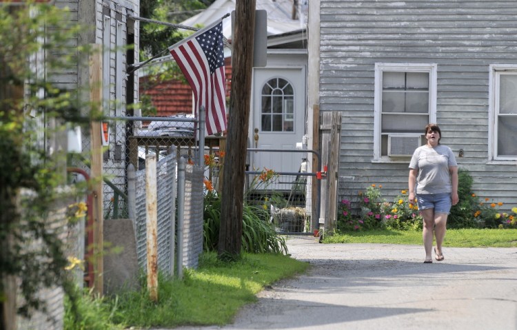 Betty Hovey, 40, walks down Carey Lane on Friday near where a man was stabbed earlier in the week.