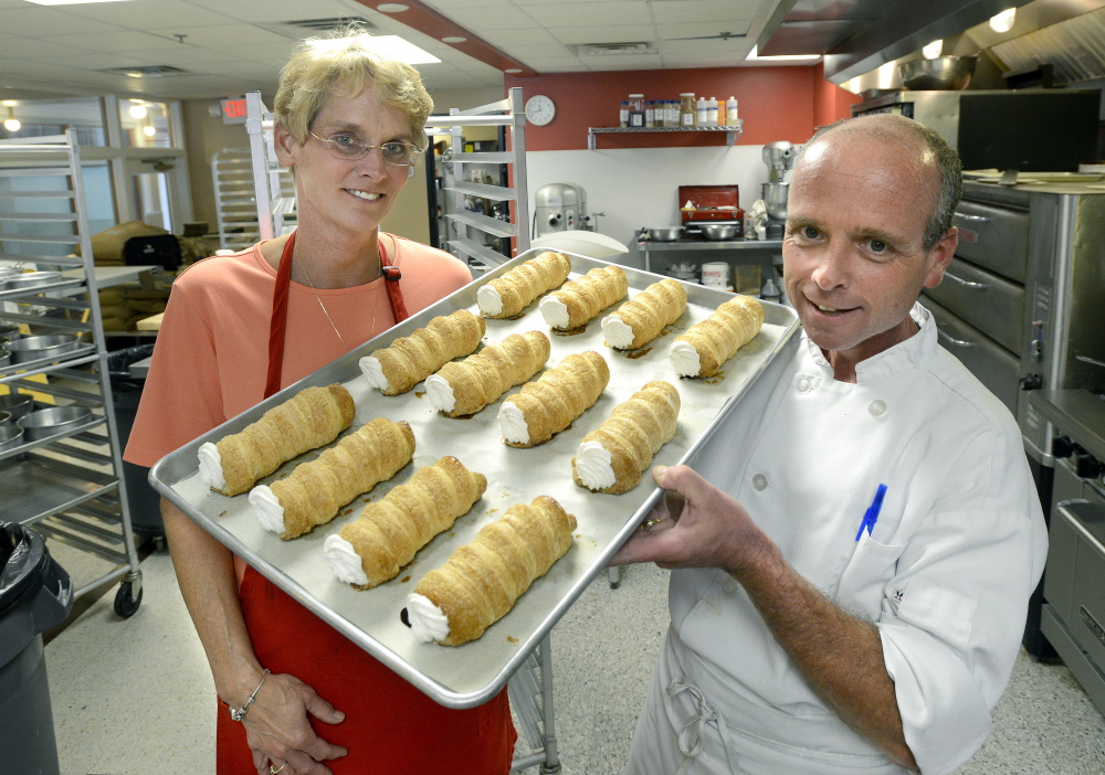 Molly and Ed Foley — and a tray of creme horns. Though they sold the business, the bakery will continue with the Foley name and assurances that the new owner will keep things as is.