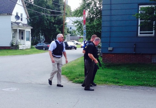 Waterville police Chief Joseph Massey, left, Deputy Chief Charles Rumsey, front, and Sgt. Lincoln Ryder look for evidence near the scene of a brief standoff on Spruce Street Friday morning. A man police believed armed with a handgun surrendered shortly after Waterville and Winslow police surrounded the house.