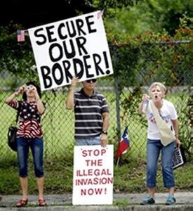 Demonstrators hold signs and yell outside the Mexican Consulate Friday, July 18, 2014, in Houston.   Prospects for action on the U.S.-Mexico border crisis faded Thursday as lawmakers traded accusations rather than solutions, raising chances that Congress will go into its summer recess without doing anything about the tens of thousands of migrant children streaming into South Texas.  (AP Photo/David J. Phillip)