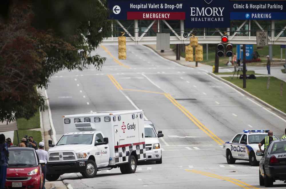 An ambulance carrying Dr. Kent Brantly arrives at Emory University Hospital in Atlanta. Another American with Ebola is expected to join him at the hospital in a few days.