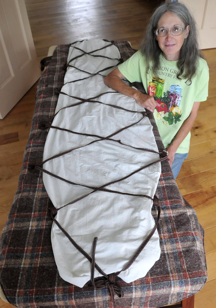 Nancy Rosalie, of Thorndike, displays a burial shroud she made from re-purposed and biodegradable materials.