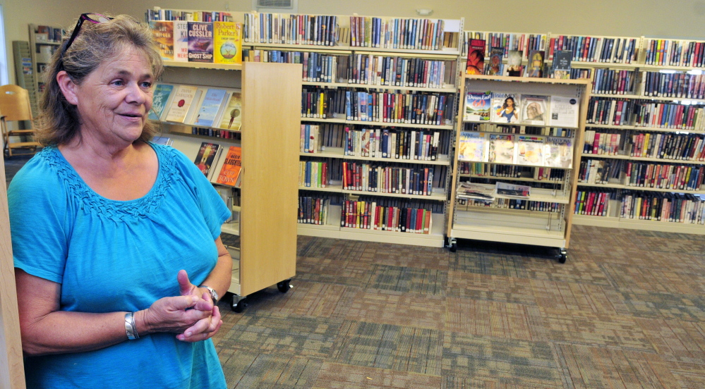Librarian Donna McClusky leads a tour of new Umberhine Public Library on Thursday in Richmond.