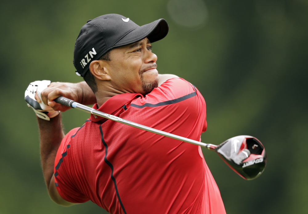 Tiger Woods watches his his tee shot on the fourth hole during the final round of the Bridgestone Invitational on Sunday at Firestone Country Club in Akron, Ohio. Woods withdrew from the tournament after experiencing back pain. Woods had returned to golf recently after recovering from back surgery.