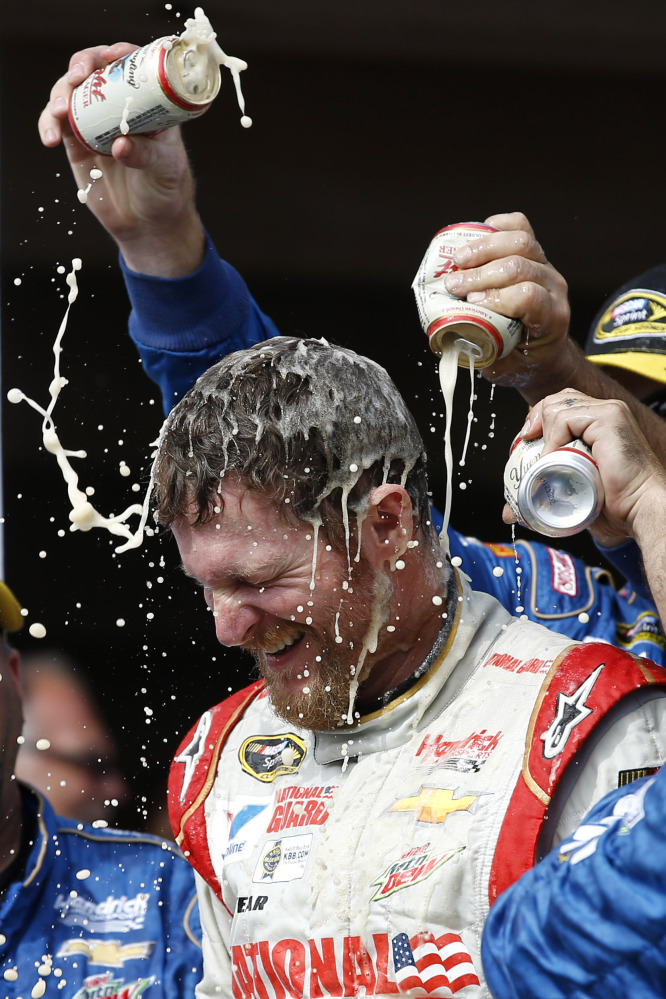 Dale Earnhardt Jr. is doused by crew members in Victory Lane after winning the NASCAR Sprint Cup Series race at Pocono Raceway on Sunday in Long Pond, Pa.
