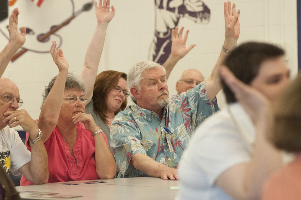 Members of Ward 6 vote with a show of hands during the Waterville Democratic caucus at Waterville Senior High School on Sunday.