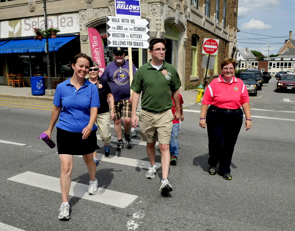 WATERVILLE,ME.-July 31: After walking 20-miles from Unity, Democrat and U.S. Senate candidate Shenna Bellows, left, crosses Main Street in Waterville to visit the Waterville Downtown Farmers Market during a campaign trek across the state on Thursday, July 31, 2014. Many people joined the walk at various places including state Rep. Henry Beck, right. (Photo by David Leaming/Staff Photographer)