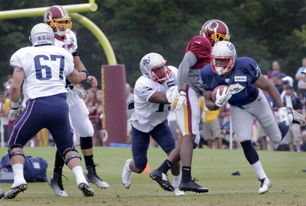 New England Patriots cornerback Darrelle Revis (24) returns a kick during practice with Washington on Monday in Richmond, Va.