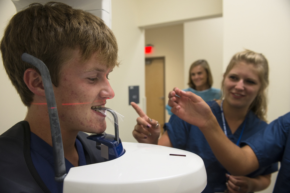 Student Evan Kane undergoes a panoramic X-ray of his teeth Monday at UNE’s dentist camp. Maine has 50 dentists per 100,000 people, compared with the national average of 61.