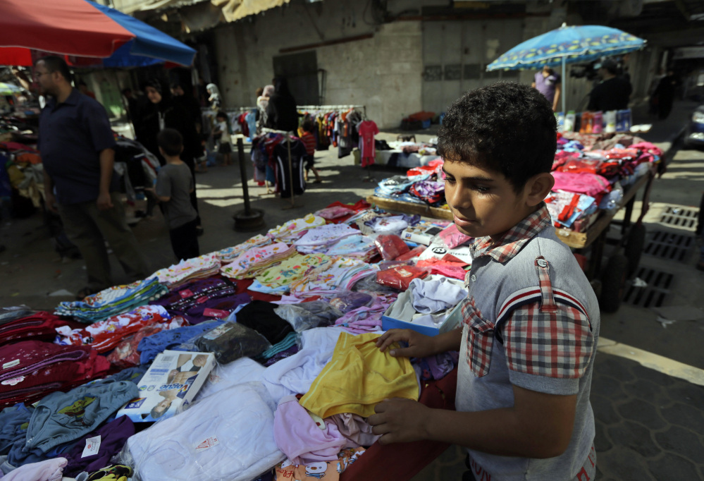 A Palestinian vendor arranges his merchandise at a market in Gaza City, northern Gaza Strip, Wednesday.