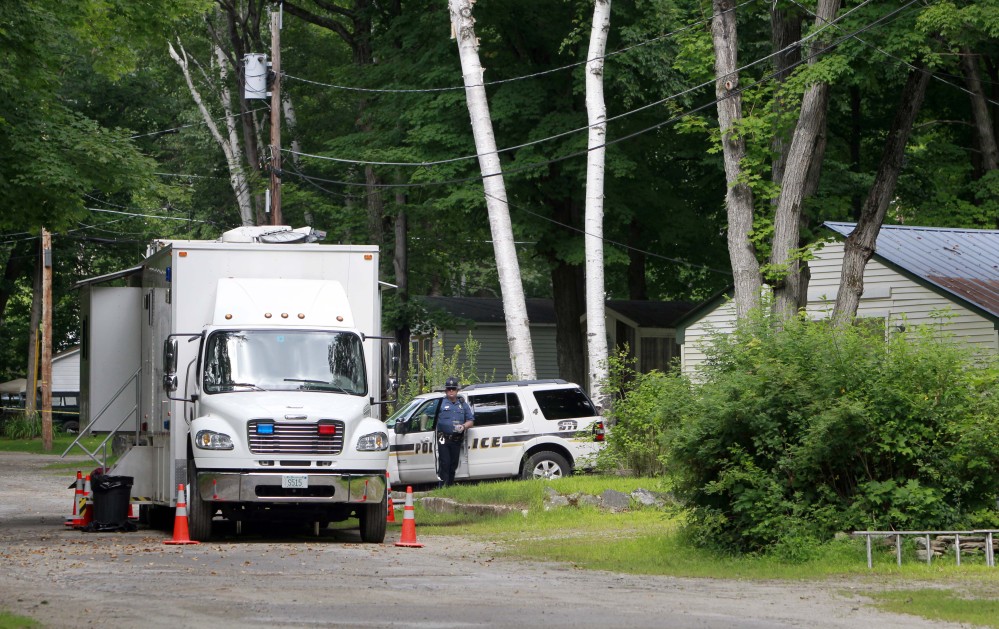 Police stand guard outside the trailer park home of Nathaniel Kibby on Wednesday in Gorham, N.H.