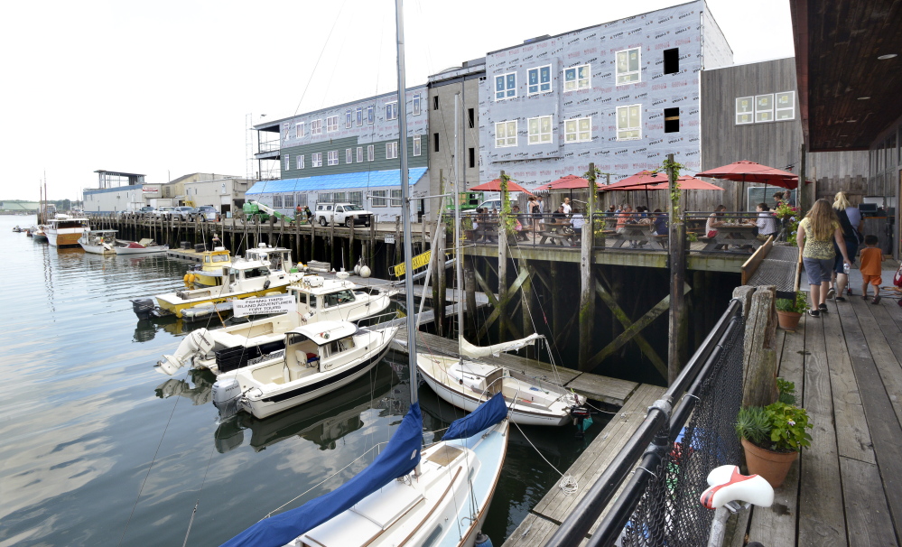 Flatbread restaurant’s outside deck and a new building that will have a new restaurant and offices are being built on Maine Wharf in Portland.