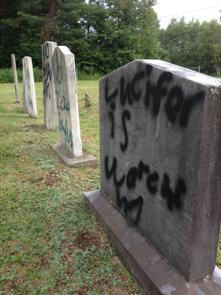 Normal:“Lucifer is watching,” proclaims a message spray-painted on a gravestone in Pleasant View Ridge Cemetery in China on Wednesday.