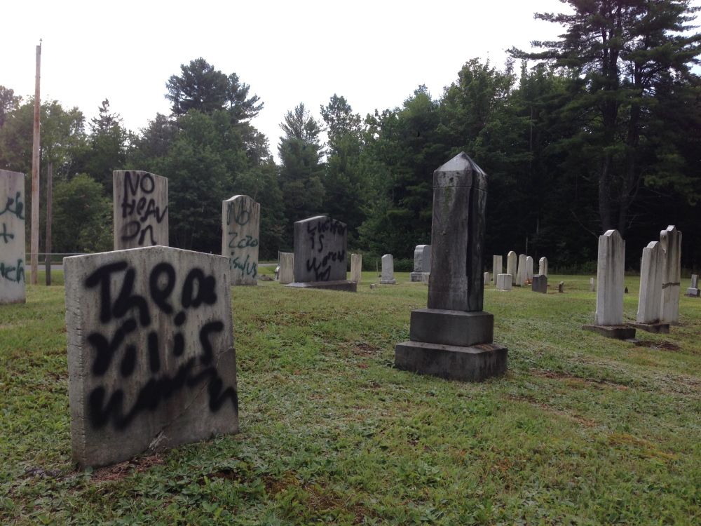 Normal:Graffiti defaces several gravestones Wednesday in Pleasant View Ridge Cemetery in China.