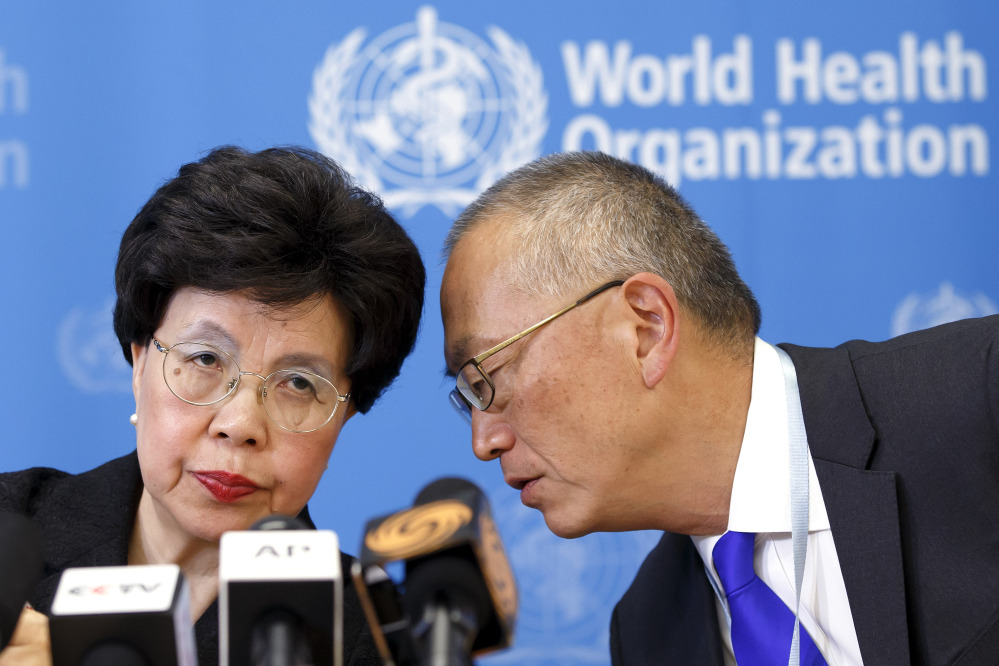 The director general of the World Health Organization, China’s Margaret Chan, and Assistant Director General for Health Security Keiji Fukuda of the U.S., right, share a word during a news conference after an emergency meeting at the headquarters of the WHO in Geneva, Switzerland, on Friday.