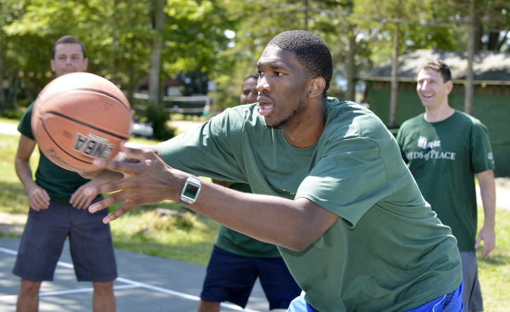 Portland Press Herald photo by John Ewing
NBA basketball players including Boston Celtic first round pick Marcus Smart, participated in the Seeds of Peace’s annual Play of Peace program at the Otisfield summer camp. NBA rookie Joel Embiid participates in some passing drills with the campers.)