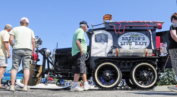 Visitors look at Richard Breton’s 1930 Ford Model A snowmobile during a car show Saturday in the Augusta Civic Center parking lot. The event was a fundraiser for the Maine Children’s Cancer Program.