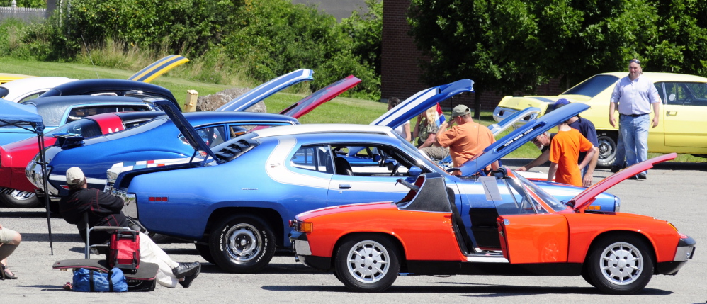 Spectators look at row of cars from the 1970s during a car show Saturday in the Augusta Civic Center parking lot. The event was a fundraiser for the Maine Children’s Cancer Program.