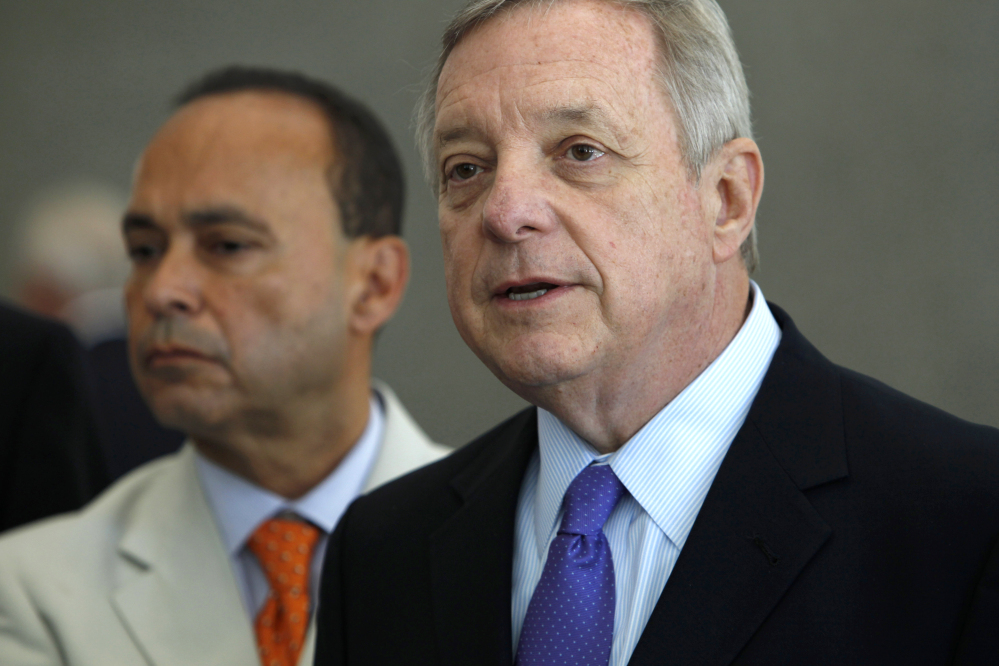The Associated Press
This Friday, June 13, 2014, file photo shows Sen. Dick Durbin, D-Ill., right, joined by Homeland Security Secretary Jeh Johnson, as he speaks during a news conference in Chicago. Islamic militants’ growing influence in Iraq and Syria are a threat to Americans, lawmakers from both political parties agreed Sunday even as they sharply disagreed on what role the United States should play in crushing them.