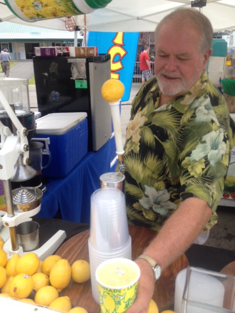 Dean Michaud, of Vero Beach, Fla., prepares fresh lemonade at his Blue Lagoon booth Sunday during the 196th annual Skowhegan State Fair.