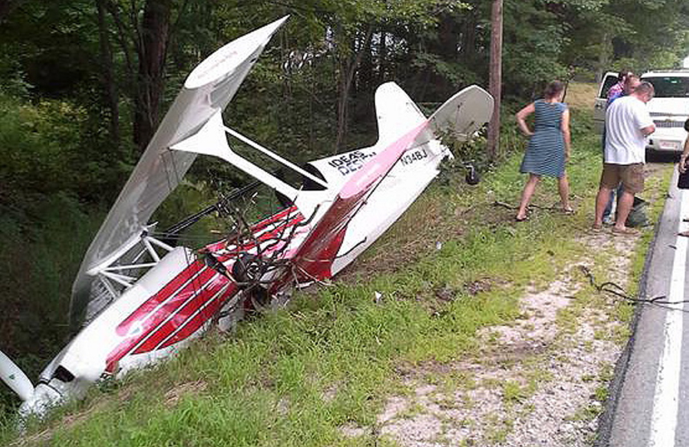A single-engine plane rests in a ditch beside Route 35 in Standish on Sunday. The pilot suffered only minor injuries.