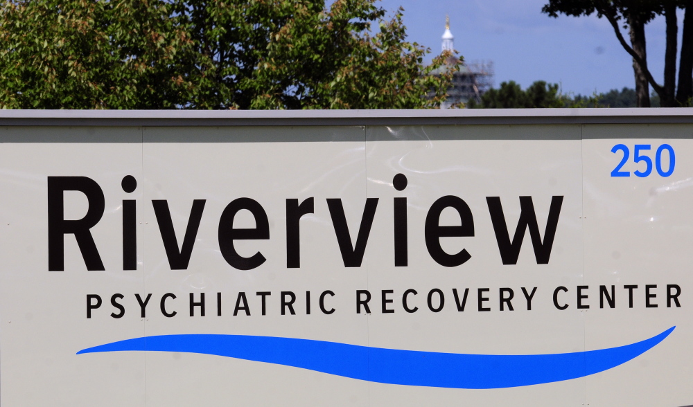 The State House dome across the Kennebec River can be seen behind the new sign reading Riverview Psychiatric Recovery Center in front of the Riverview Psychiatric Center.