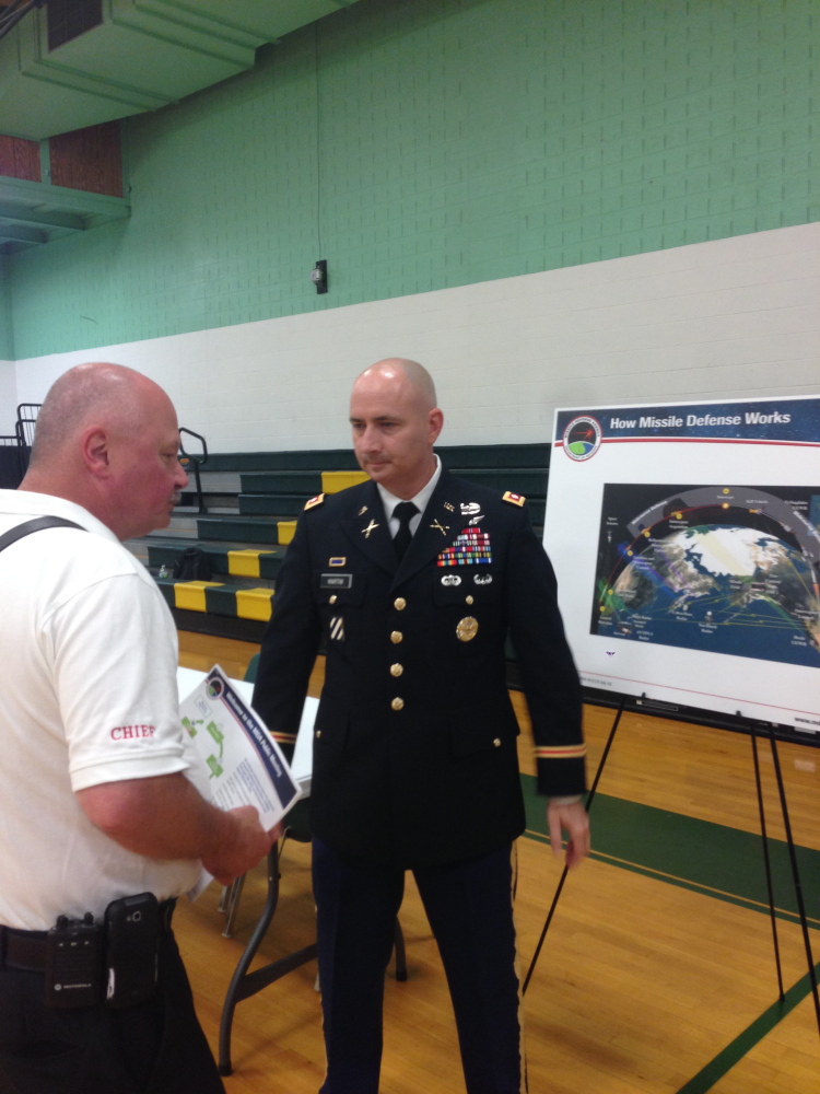 Plain Text:Rangeley Fire Chief Tim Pellerin, left, speaks with Lt. Col. Dan Martin at a public meeting on the potential environmental effect of construction of a missile interceptor facility in Redington Township.