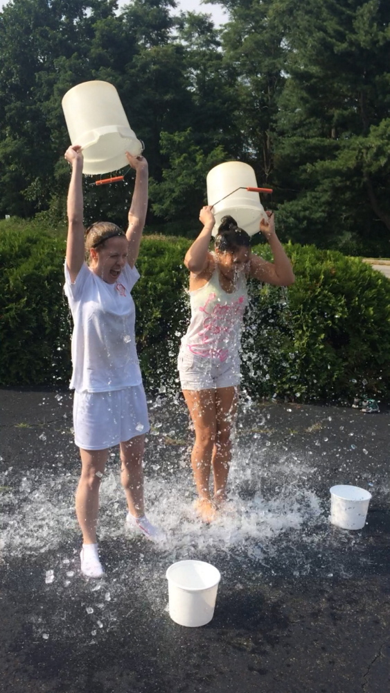 Jillian St. Louis and, at right, Danna Vaughn take the ice bucket challenge.