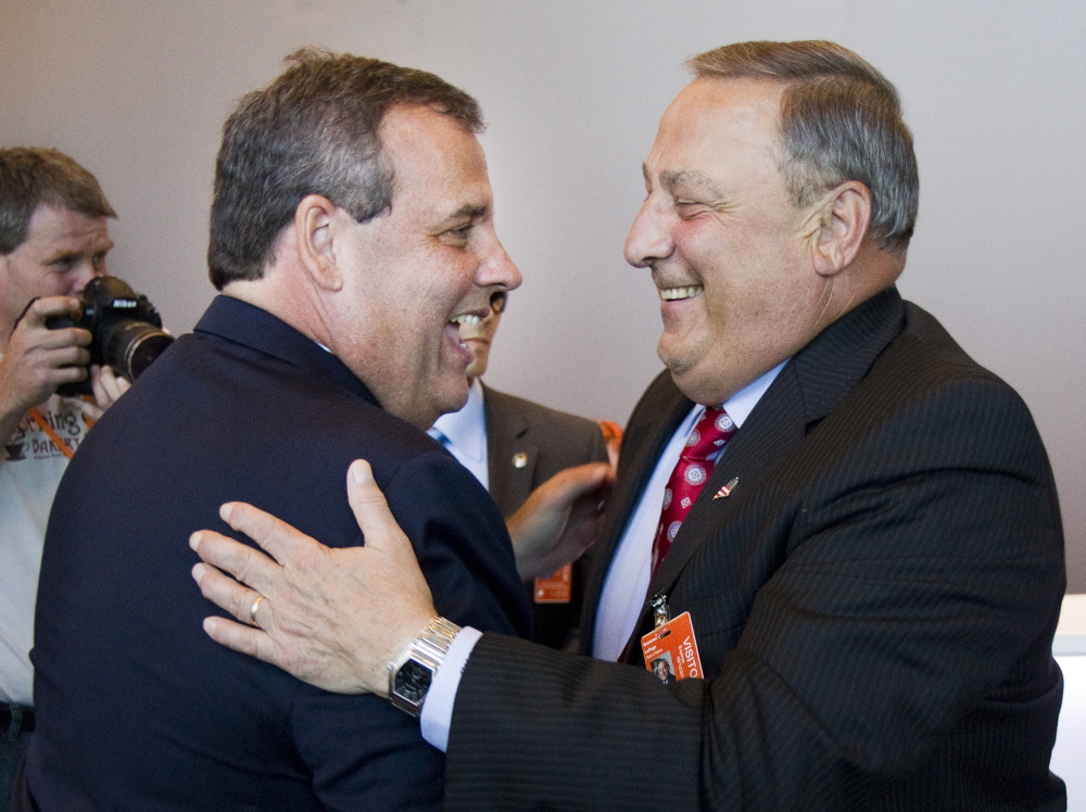 New Jersey Gov. Chris Christie and Maine Gov. Paul LePage greet one another before a tour of C&L Aviation in Bangor on Tuesday.