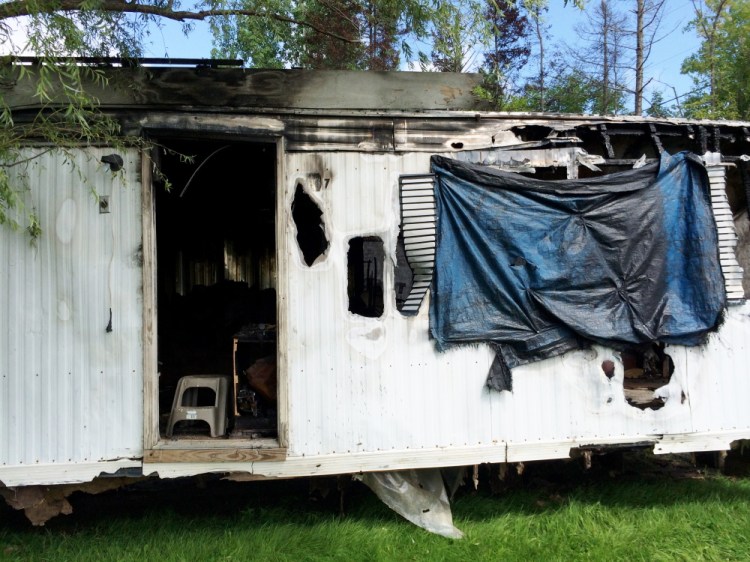 A Farmington mobile home damaged by a March fire must be torn down by mid-October.