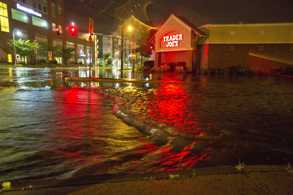 Floodwaters engulf Preble Street late Wednesday night near the Trader Joe’s store on Marginal Way in Portland. Marginal Way had to be closed overnight, but by Thursday morning it was reopened to traffic.