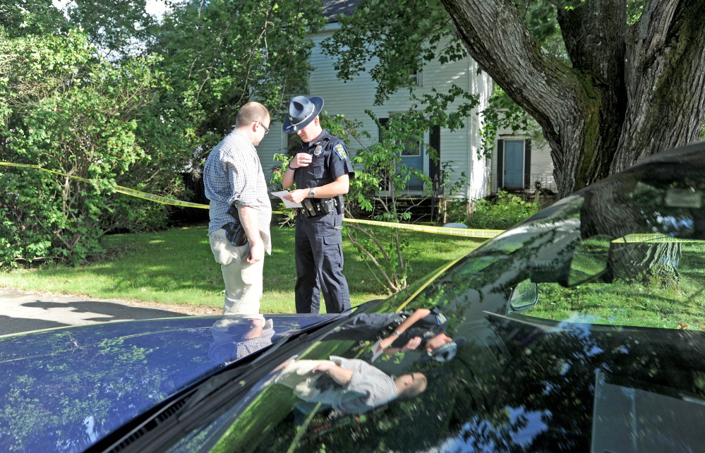 Skowhegan police officers stand outside 23 Chestnut St. after resident Wayne Shaw was seriously injured by another man on Aug. 14, police said.
