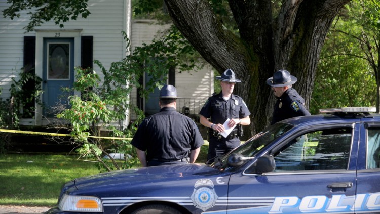 Skowhegan police officers stand outside 23 Chestnut St. after resident Wayne Shaw was seriously injured by another man, police said on Thursday.