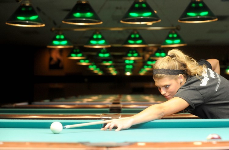 Photo by Michael G. Seamans/Staff Photographer
Taylor Reynolds, a senior at Lawrence High School, lines up a shot during a game of billiards Friday at TJ’s Billiards in Waterville. Reynolds is also taking aim at the junior world title November in Shanghai, China.