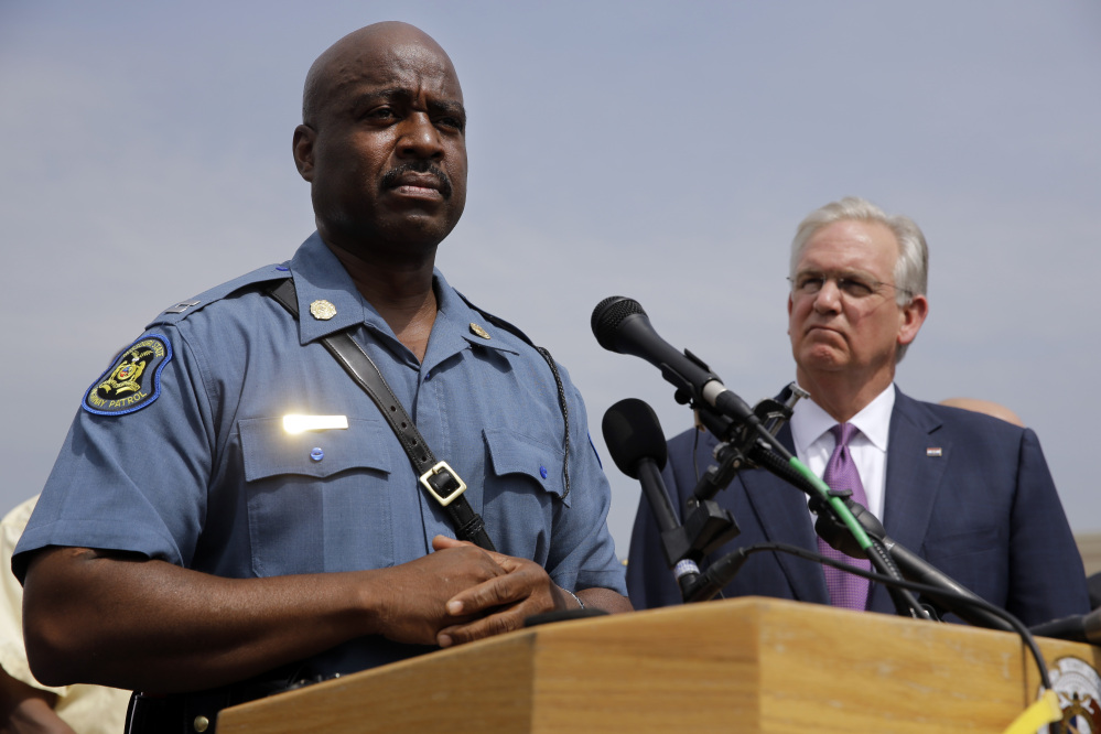 Capt. Ron Johnson of the Missouri Highway Patrol, left, and Missouri Gov. Jay Nixon take part in a news conference Friday in Ferguson, Mo. Nixon assigned protest oversight to Johnson after violent protests in Ferguson erupted in the wake of the fatal shooting of  Michael Brown by a police officer on Aug. 9.