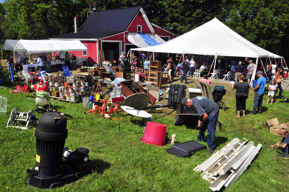 An auction to raise money for a new fire station was held under a tent in front of the station during the Coopers Mills Volunteer Fire Department charity auction on Saturday.