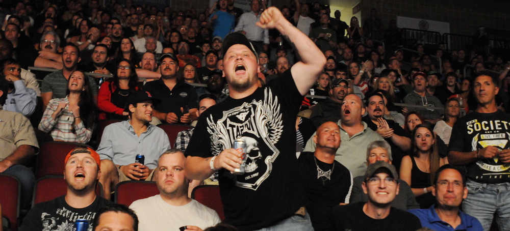 Bangor, Maine--08/16/2014-- A UFC fan cheers his favorite fighter during the Tom Watson, Sam Alvey middleweight bout at the Cross Insurance Center in Bangor on Saturday. 
 Kevin Bennett Photo