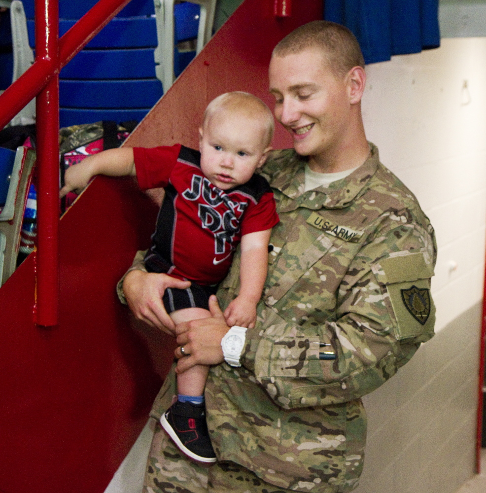 Spc Devin Allen of Maine’s 133rd Engineer Battalion, recently back from deployment in Afghanastan, enjoys time with his son Drake, 15 months, before being honored during a ceremony at the Colisee in Lewiston on Sunday.