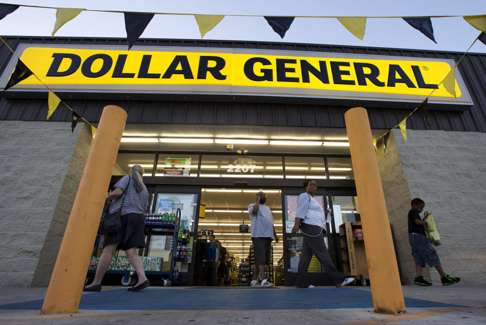 In this Wednesday, Sept. 25, 2013, file photo, customers exit a Dollar General store, in San Antonio.