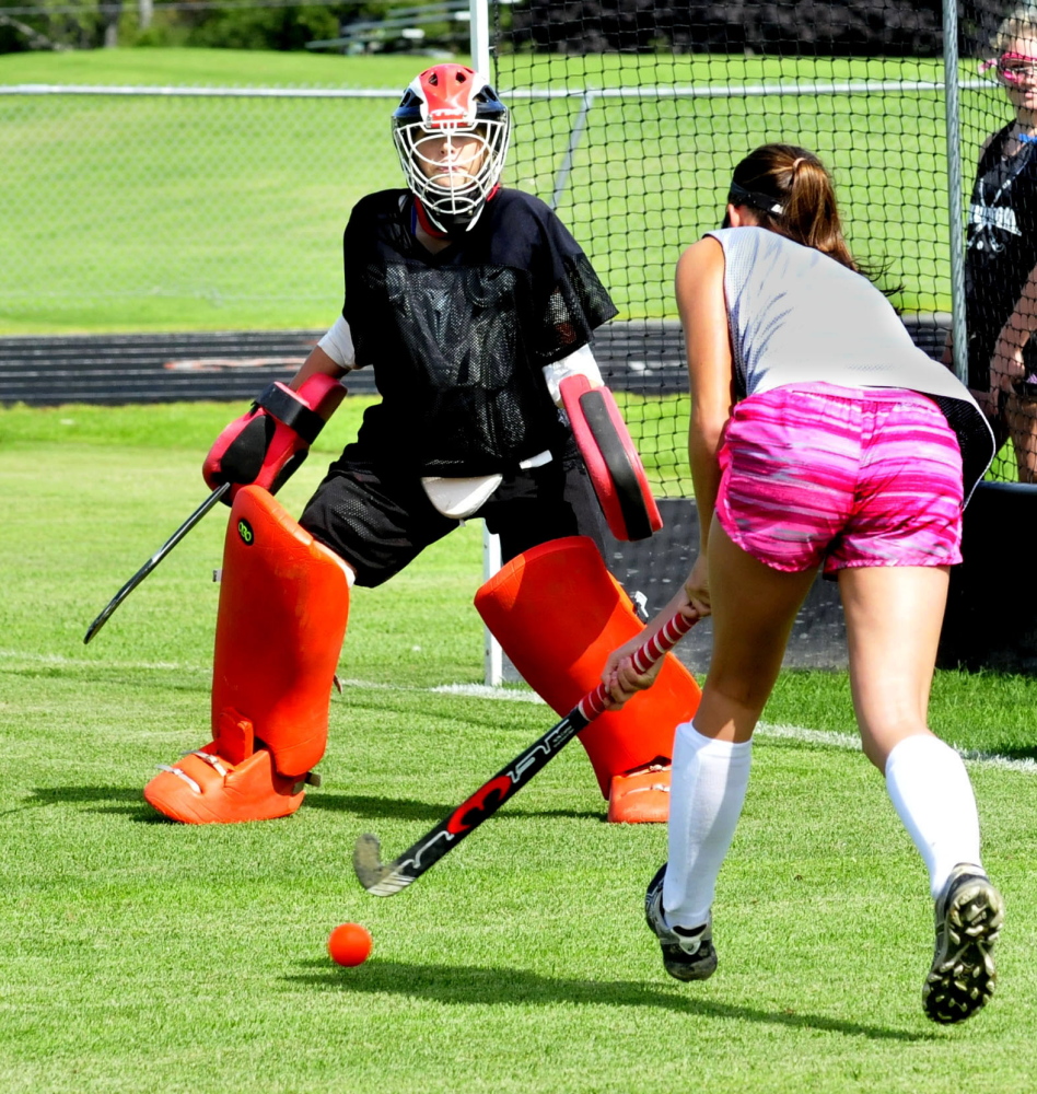 Skowhegan Area field hockey goalie Kelsey Robinson guards net as Cassidy Clements approaches during first practice of season on Monday. It was the first day of fall sports practice for schools throughout the area.