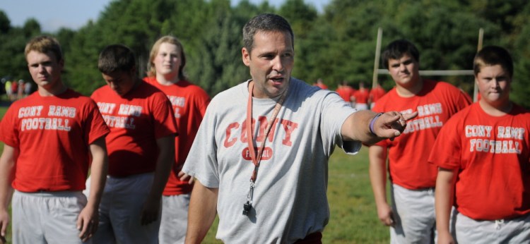 Cony High School football coach Robby Vachon oversees a drill during the first practice of the season Monday.