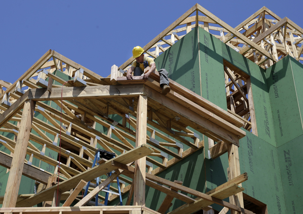 In this July 30 photograph, a builder works on the construction of new homes in Belmar, N.J.