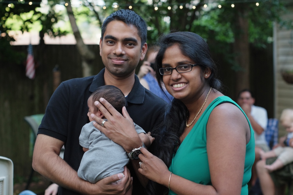 Wasim Ahmad and his wife, Lakshmi Ramsoondar-Ahmad, pose with their newborn son in Merrick, N.Y. Two days after his son was born, Ahmad bought the website domain with his son’s name.