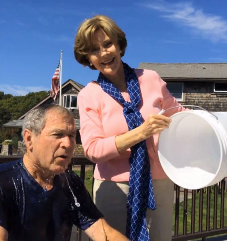 In these images from video posted on Facebook, courtesy of the George W. Bush Presidential Center, former President George W. Bush reacts after taking part in the ice bucket challenge, with the help of his wife, Laura Bush, in Kennebunkport. Notable figures are participating in the campaign to raise money for the fight against ALS, or Lou Gehrig’s disease.