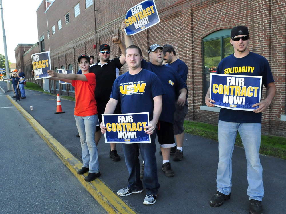 United Steelworkers Local 449 members demonstrate outside the Huhtamaki plant on Wednesday in Waterville. Union member Alan Rose, right, said the workers have been without a contract for two years.