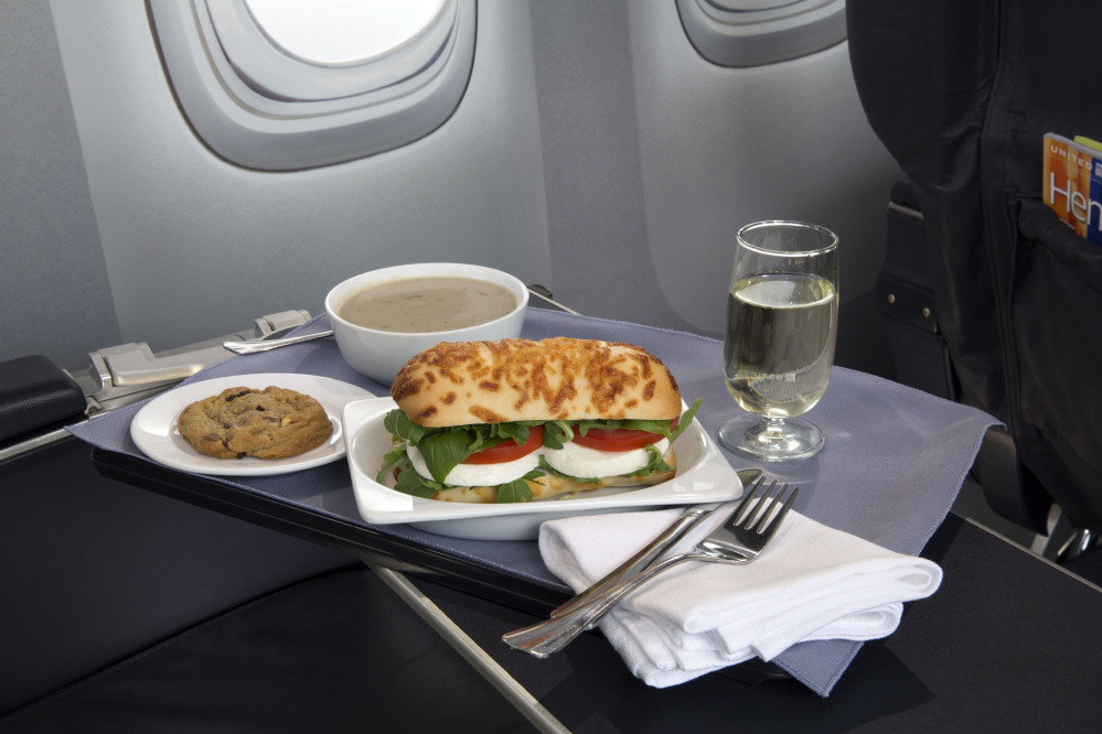 United Airlines is touting its caprese on asiago baguette sandwich, one of a variety of the airline’s new first-class food options.